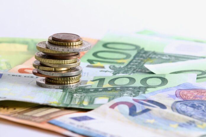 Euro,Coins,Stacked,On,Each,Other,In,Different,Positions,Over